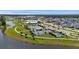 Aerial view of neighborhood with a lake, pool, tennis courts, and attractive landscaping on a sunny day at 318 Ripple Park Dr, Summerville, SC 29486