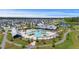Aerial view of a pool, clubhouse, and walking paths surrounded by lush greenery and colorful homes at 318 Ripple Park Dr, Summerville, SC 29486
