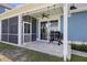 Covered back porch with hanging swings, a ceiling fan, and a grill for outdoor entertaining at 318 Ripple Park Dr, Summerville, SC 29486