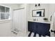 Well-lit bathroom with a vanity, large mirror, and shower featuring modern finishes at 318 Ripple Park Dr, Summerville, SC 29486