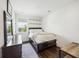 Cozy bedroom features a dark wood bed frame and floors, light walls, and natural light from a window at 318 Ripple Park Dr, Summerville, SC 29486