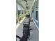 Inviting front porch with rocking chairs, swing, and stylish lighting fixtures at 318 Ripple Park Dr, Summerville, SC 29486