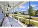 Relax on this inviting front porch swing, complete with a ceiling fan for warm days at 318 Ripple Park Dr, Summerville, SC 29486