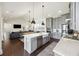Open-concept kitchen with a large island, stainless appliances, gray cabinets, and a seamless flow to living spaces at 318 Ripple Park Dr, Summerville, SC 29486