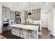 Modern kitchen boasts an island with seating, stainless appliances, gray cabinetry, and stylish pendant lighting at 318 Ripple Park Dr, Summerville, SC 29486