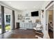 Entertainment area with gray cabinets, a TV, mini fridge, and sliding glass doors to the outdoors at 318 Ripple Park Dr, Summerville, SC 29486