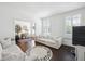 Bright living room with dark wood floors, a plush white sofa, and ample natural light at 318 Ripple Park Dr, Summerville, SC 29486