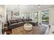 Bright living room with a large sectional, stylish rug, and access to a patio for seamless indoor-outdoor living at 318 Ripple Park Dr, Summerville, SC 29486