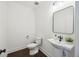 Elegant powder room with a sleek pedestal sink, modern black faucet, and a stylish framed mirror at 318 Ripple Park Dr, Summerville, SC 29486