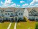 Aerial view of townhomes with symmetrical layout and manicured green lawns at 326 Surfbird Rd # 388, Summerville, SC 29486