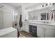 Bright bathroom with dual vanity, large mirror, glass shower, and plank flooring at 326 Surfbird Rd # 388, Summerville, SC 29486