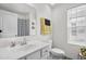 Clean bathroom featuring single vanity, toilet, mirror, and a window providing plenty of natural light at 326 Surfbird Rd # 388, Summerville, SC 29486