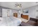Another view of the spacious primary bedroom features a ceiling fan, comfortable chair, and closet at 326 Surfbird Rd # 388, Summerville, SC 29486
