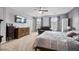 Spacious primary bedroom featuring a ceiling fan, comfortable chair, and large windows for natural light at 326 Surfbird Rd # 388, Summerville, SC 29486