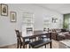 Dining room with natural light, hard wood floors and modern table next to living room at 326 Surfbird Rd # 388, Summerville, SC 29486