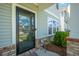 Charming front door with a glass panel, sidelights, and a small table with potted plant at 326 Surfbird Rd # 388, Summerville, SC 29486