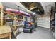 Well-organized garage with overhead kayak storage, pegboard, epoxy floor, and a comfortable armchair at 326 Surfbird Rd # 388, Summerville, SC 29486