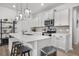 Modern kitchen with white cabinets, stainless steel appliances, tile backsplash, and island with seating at 326 Surfbird Rd # 388, Summerville, SC 29486