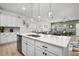 Open kitchen with hardwood floors, white cabinetry, stainless steel appliances and island with breakfast bar at 326 Surfbird Rd # 388, Summerville, SC 29486