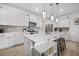 Bright kitchen with white cabinetry, stainless steel appliances, pendant lighting, and spacious island at 326 Surfbird Rd # 388, Summerville, SC 29486
