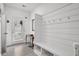 Bright mudroom features shiplap accent wall with hooks, bench and storage, with a doorway to the exterior at 326 Surfbird Rd # 388, Summerville, SC 29486