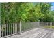 Spacious back deck with white railing offering a scenic view of the tree-filled backyard at 3751 Copahee Sound Dr, Mount Pleasant, SC 29466
