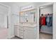 Bright bathroom featuring double sinks, a large mirror, and a walk-in closet for ample storage at 3751 Copahee Sound Dr, Mount Pleasant, SC 29466