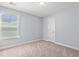 A carpeted bedroom features natural light from the window and white trim at 3751 Copahee Sound Dr, Mount Pleasant, SC 29466
