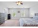 Spacious bedroom featuring a ceiling fan, plush carpet, and ample natural light from two windows at 3751 Copahee Sound Dr, Mount Pleasant, SC 29466