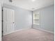 A carpeted bedroom features natural light from the window and white trim at 3751 Copahee Sound Dr, Mount Pleasant, SC 29466