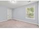 A carpeted bedroom features natural light from the window and white trim at 3751 Copahee Sound Dr, Mount Pleasant, SC 29466