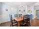 Elegant dining room with wainscoting, hardwood floors, and decorative lighting fixture at 3751 Copahee Sound Dr, Mount Pleasant, SC 29466