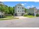 Charming two-story home featuring double balconies, elevated design, and lush landscaping at 3751 Copahee Sound Dr, Mount Pleasant, SC 29466