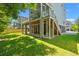 Rear exterior view of home with multi-level decks and a well-maintained lawn at 3751 Copahee Sound Dr, Mount Pleasant, SC 29466
