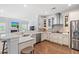 Bright kitchen boasts stainless steel appliances, marble countertops, and white cabinets at 3751 Copahee Sound Dr, Mount Pleasant, SC 29466
