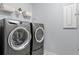A laundry room featuring a front load washer and dryer, shelving, and gray paint at 3751 Copahee Sound Dr, Mount Pleasant, SC 29466