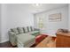 Living room showcases a comfortable sectional sofa, colorful rug, and natural light from the window at 3751 Copahee Sound Dr, Mount Pleasant, SC 29466