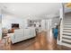 Spacious living room with hardwood floors seamlessly connects the kitchen and staircase at 3751 Copahee Sound Dr, Mount Pleasant, SC 29466