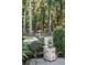 Outdoor seating area with a chair surrounded by manicured greenery and flowers in a serene backyard setting at 3751 St Ellens Dr, Mount Pleasant, SC 29466