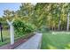 Serene backyard with manicured lawn, mature trees, and a charming walkway, perfect for relaxation and outdoor enjoyment at 3751 St Ellens Dr, Mount Pleasant, SC 29466