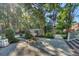 Manicured backyard with a stone path, fountain, mature trees, and lush greenery, perfect for outdoor enjoyment at 3751 St Ellens Dr, Mount Pleasant, SC 29466