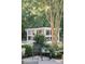 A backyard scene featuring a chicken coop, chair, and lush greenery, creating a peaceful outdoor retreat at 3751 St Ellens Dr, Mount Pleasant, SC 29466