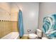 Tiled bathroom features a shower and tub with a blue shower curtain at 3751 St Ellens Dr, Mount Pleasant, SC 29466