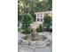 Stone water fountain in a landscaped backyard with a chicken coop in the background adding a rustic touch at 3751 St Ellens Dr, Mount Pleasant, SC 29466