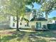 View of the home's backyard with a wooden deck, mature trees, and a white vinyl exterior at 3784 Scotts Mill Dr, North Charleston, SC 29420