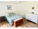 Bright bedroom with a decorative wall art, wood floors, and dresser at 3784 Scotts Mill Dr, North Charleston, SC 29420