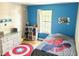 Fun bedroom with blue accent wall and comic book themed décor at 3784 Scotts Mill Dr, North Charleston, SC 29420