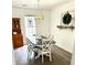Bright dining room with a chandelier, natural light, gray wood-look flooring, and traditional furnishings at 3784 Scotts Mill Dr, North Charleston, SC 29420