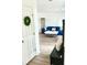 Welcoming entryway with bright white walls, gray plank flooring, leading to a sunlit living space with blue sofa at 3784 Scotts Mill Dr, North Charleston, SC 29420