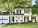 Charming two-story home featuring a manicured lawn, light blue front door and a basketball hoop over the garage at 3784 Scotts Mill Dr, North Charleston, SC 29420